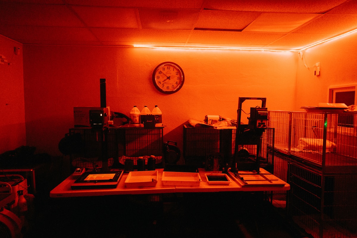 A photographic darkroom with trays and an enlarger