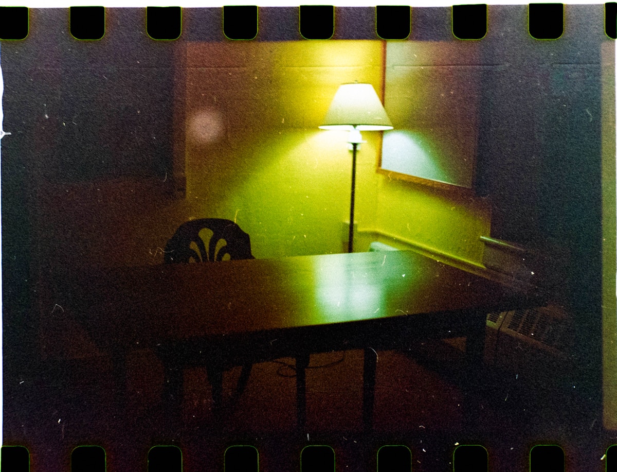 A film negative frame of a lamp-lit desk and chair